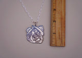 Hand-Carved Kissin’ Pendent